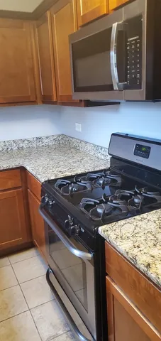 a stove top oven sitting inside of a kitchen