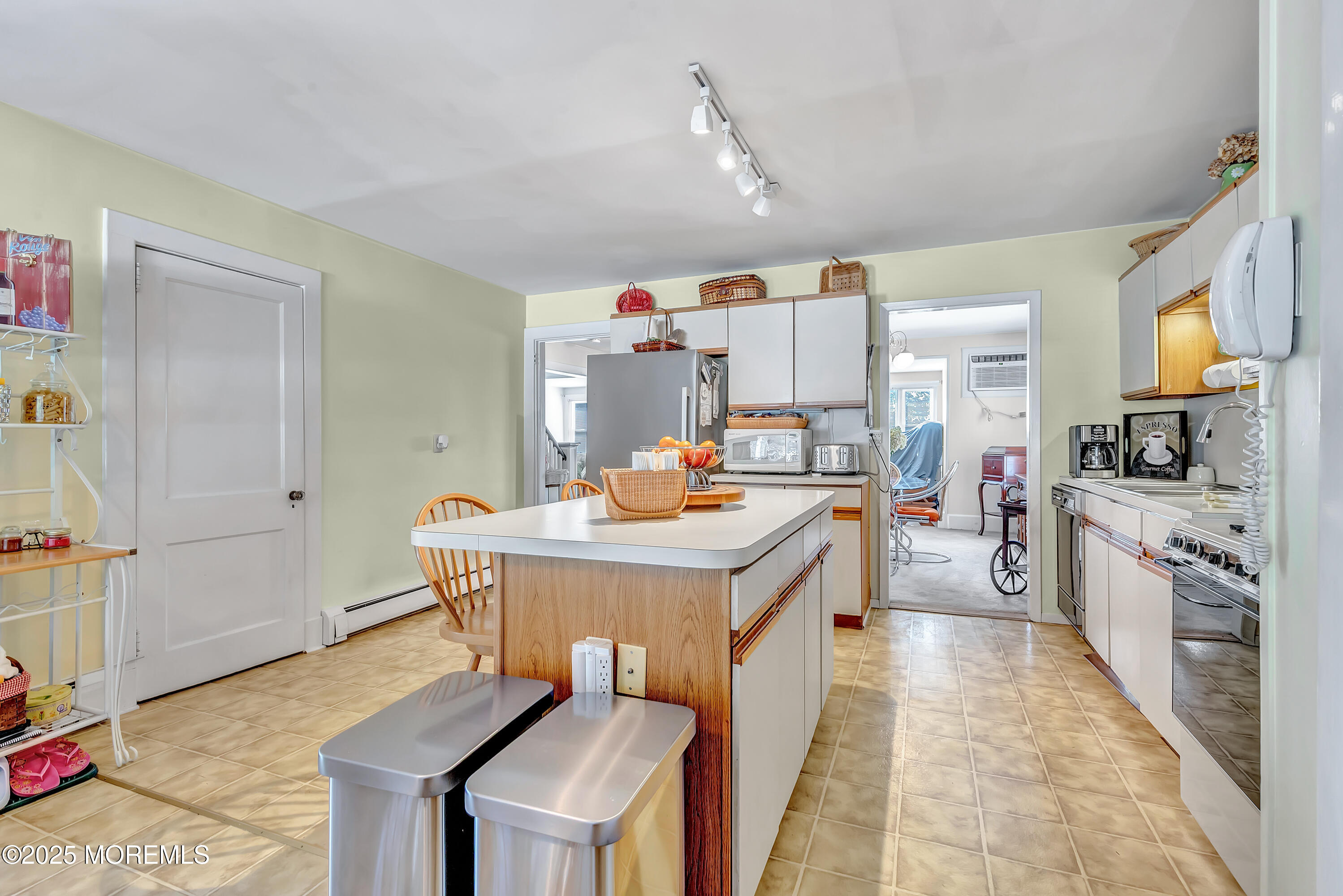 390 Conover Place Red Bank, NJ 07701 - Photo 15 of 39 a kitchen view with stainless steel appliances kitchen island granite countertop a sink and a refrigerator