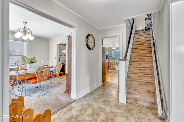 a view of a hallway with a chandelier fan