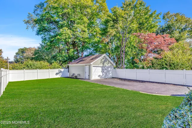 a view of a house with a yard and potted plants