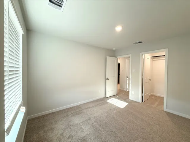 an empty room with a empty space and windows