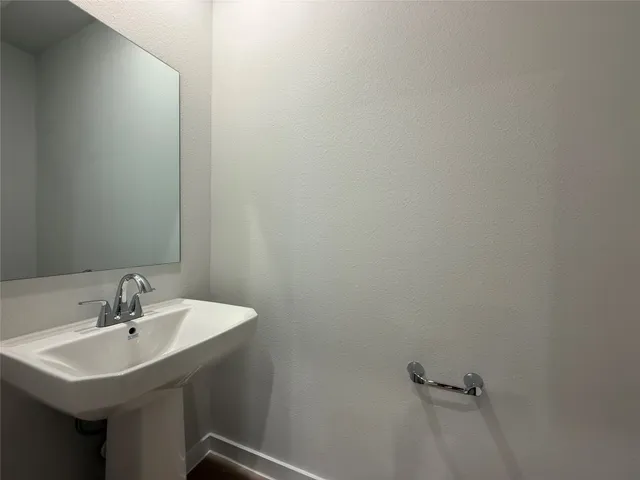 a bathroom with a sink a mirror and vanity
