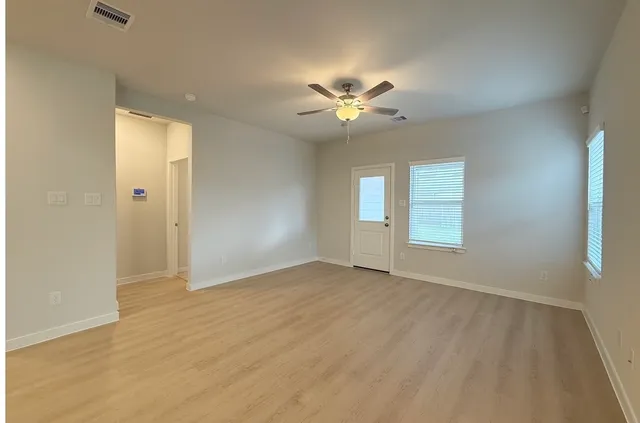 a view of an empty room with a window