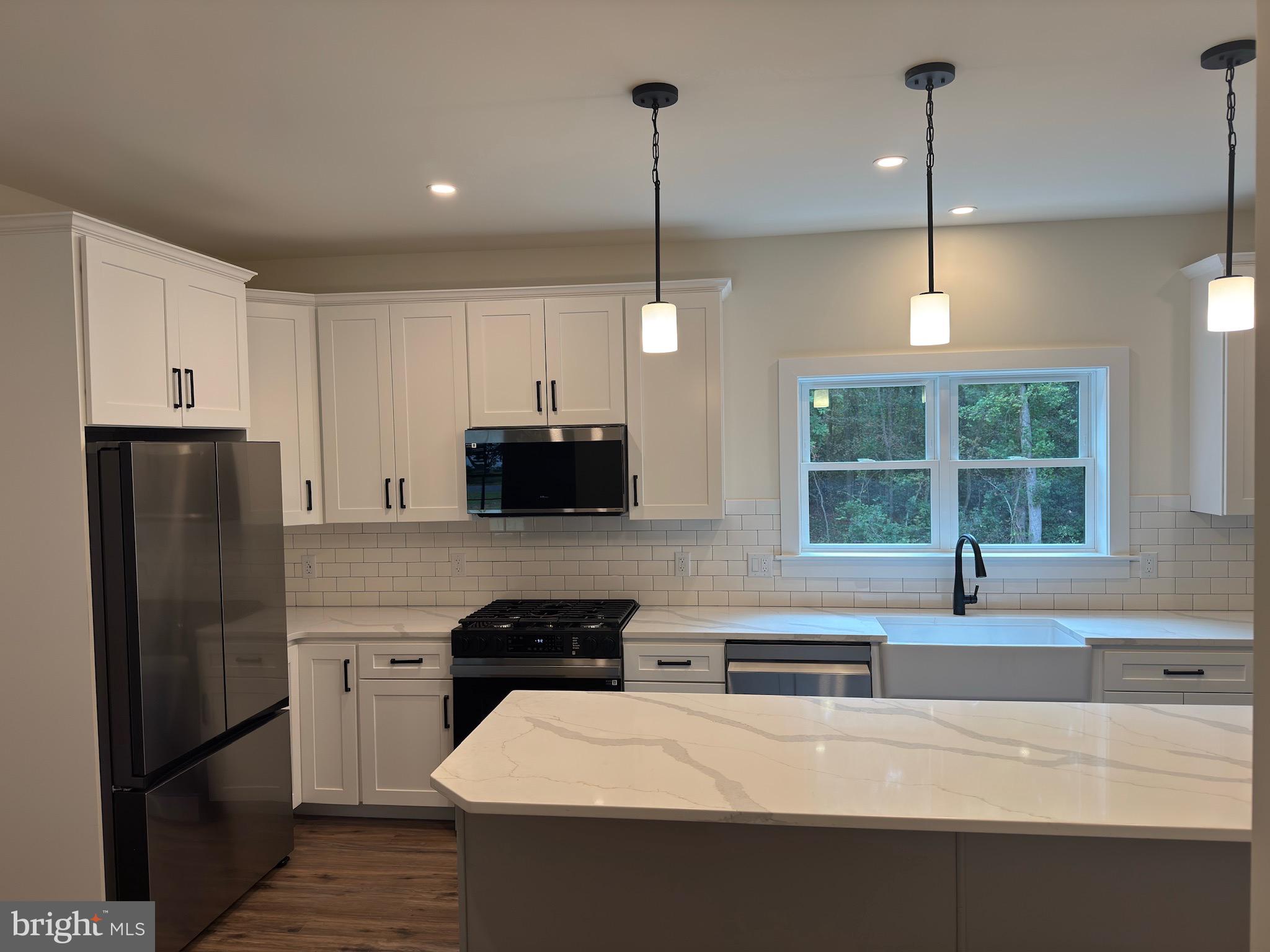 14 Wynn Road Tabernacle, NJ 08088 - Photo 11 of 33 a kitchen with stainless steel appliances a stove a sink and a refrigerator