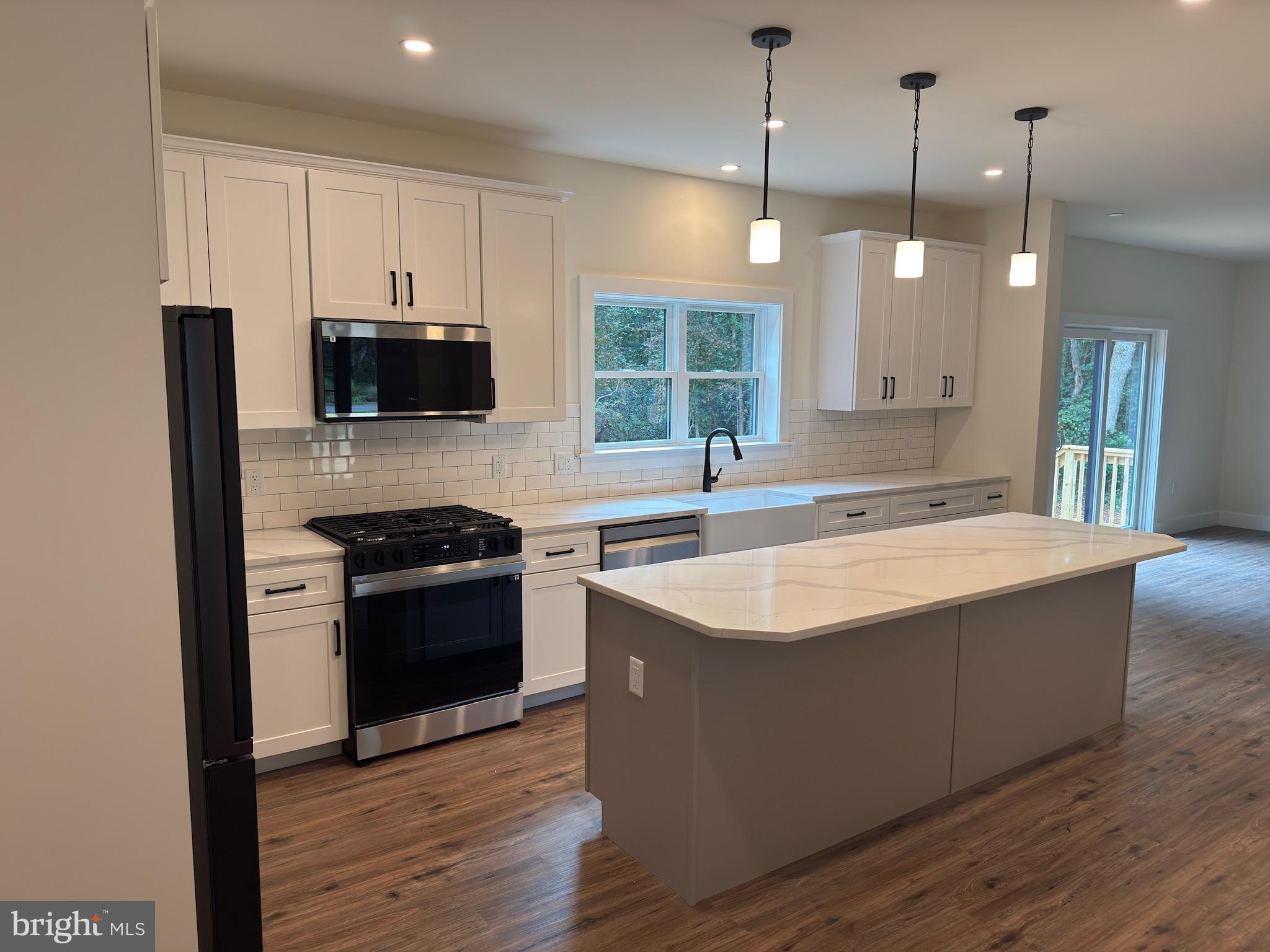 14 Wynn Road Tabernacle, NJ 08088 - Photo 12 of 33 a kitchen with stainless steel appliances kitchen island granite countertop a sink a stove and a wooden floors