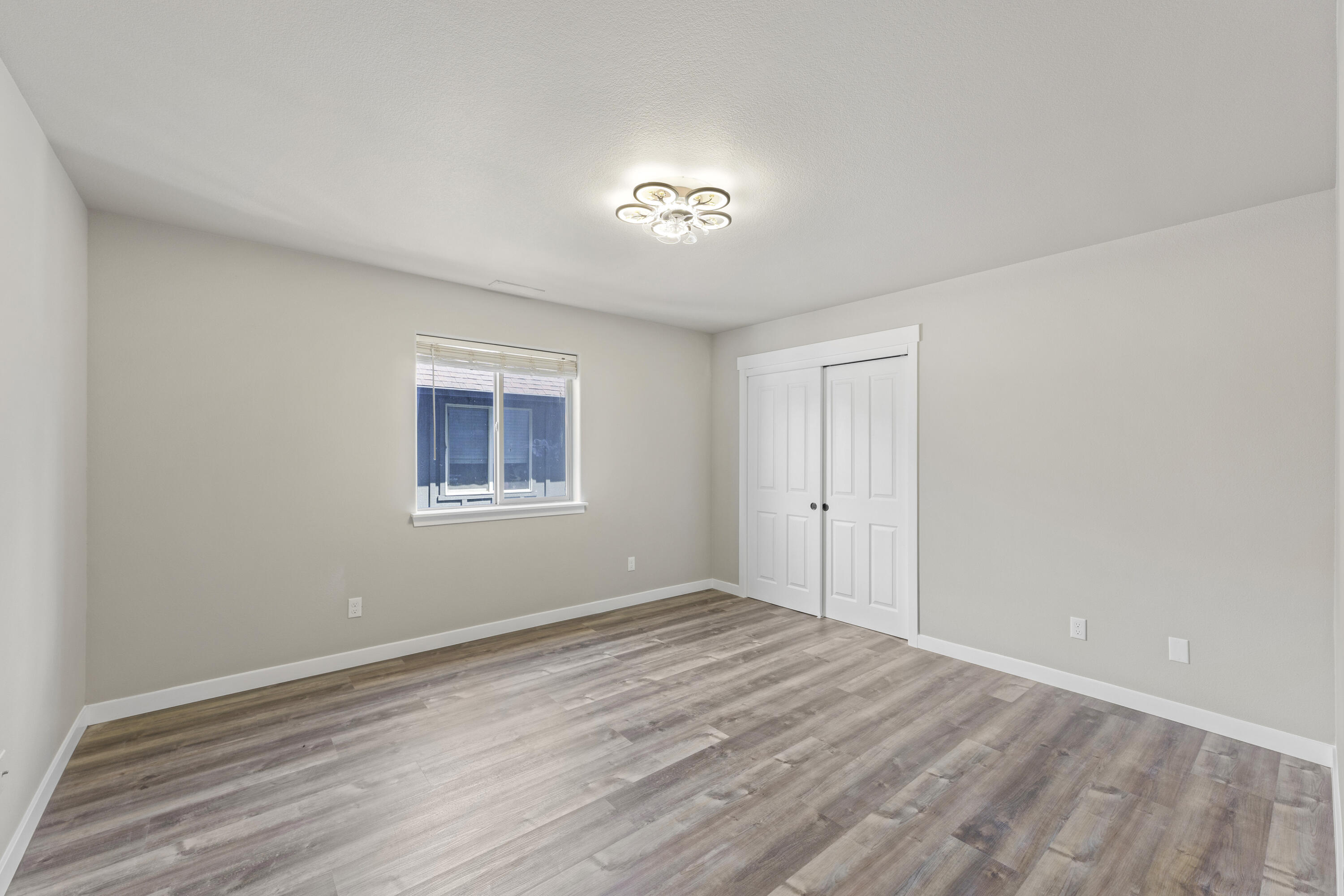 21189 Ritz Place Bend, OR 97702 - Photo 30 of 37 a view of empty room with wooden floor and fan