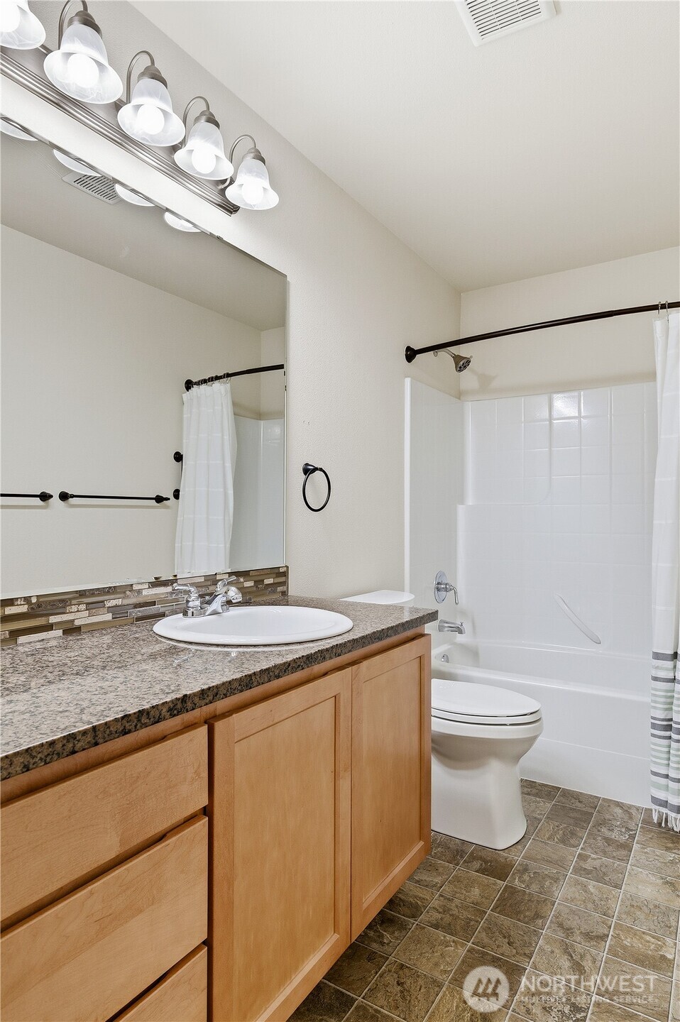 3043 Scotland Alley Mount Vernon, WA 98273 - Photo 24 of 32 a bathroom with a granite countertop sink a toilet a mirror and bathtub
