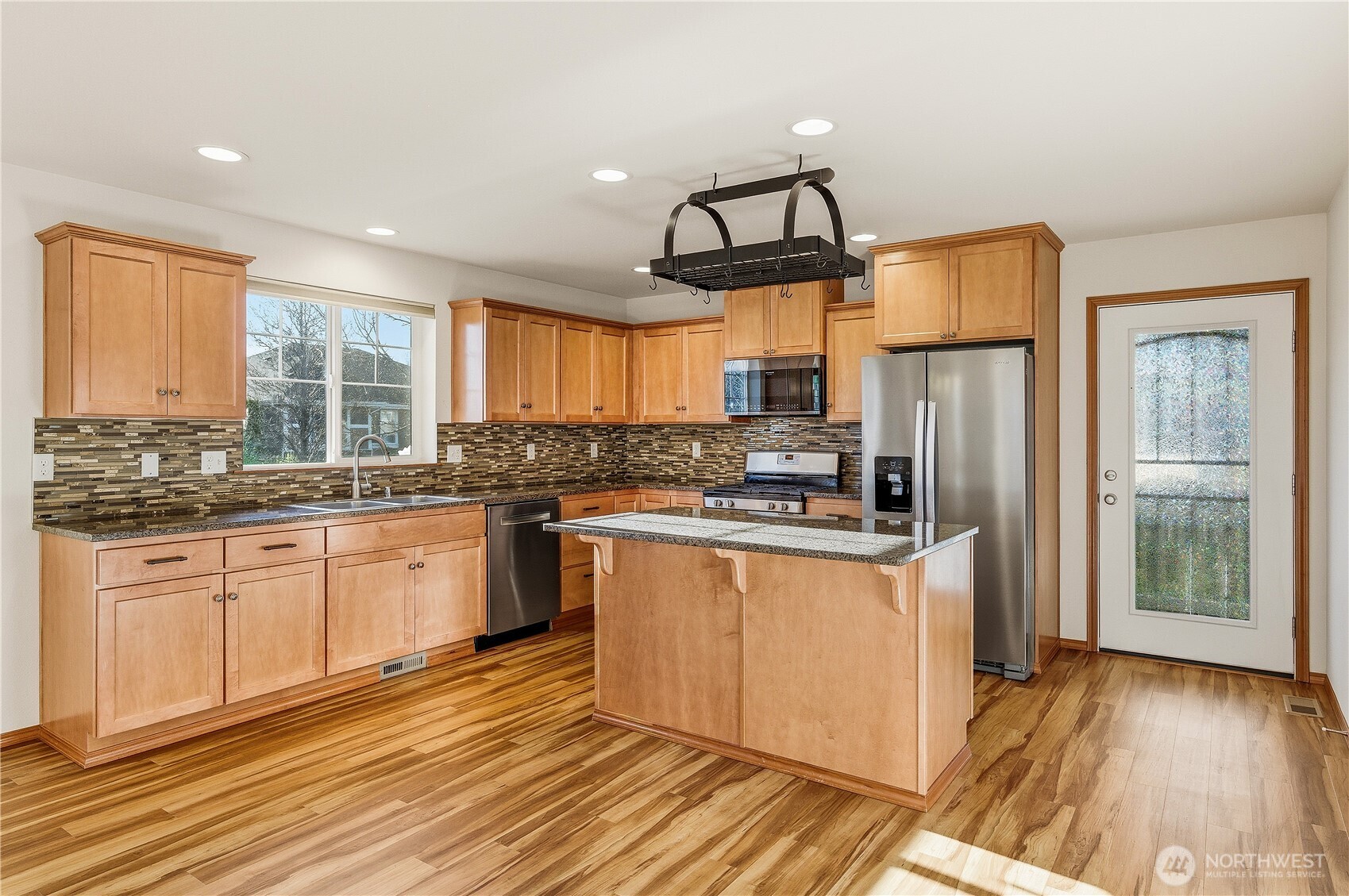 3043 Scotland Alley Mount Vernon, WA 98273 - Photo 8 of 32 a kitchen with stainless steel appliances granite countertop a refrigerator a sink dishwasher a stove and white countertops with wooden floor