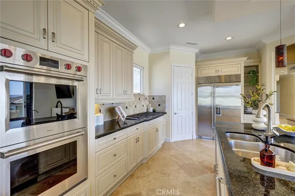 a kitchen with stainless steel appliances granite countertop a stove and cabinets