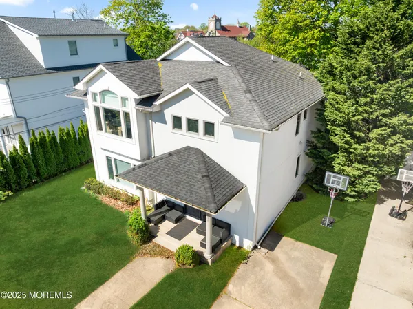 a aerial view of a house with a yard table and chairs