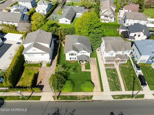 an aerial view of multiple houses with yard
