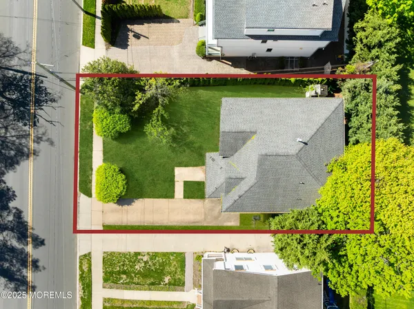an aerial view of a house with a garden and yard