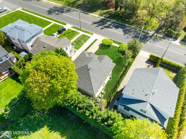 an aerial view of a house with a garden and swimming pool