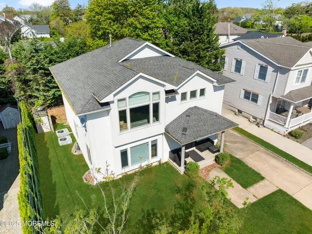 a aerial view of a house with a yard table and chairs