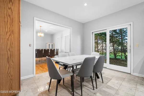 a view of a dining room with furniture and a potted plant