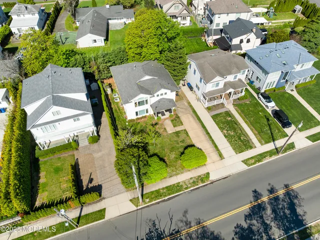 an aerial view of multiple houses with yard