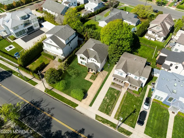 an aerial view of a house with a garden and yard