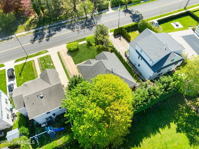 an aerial view of a house with a garden and swimming pool