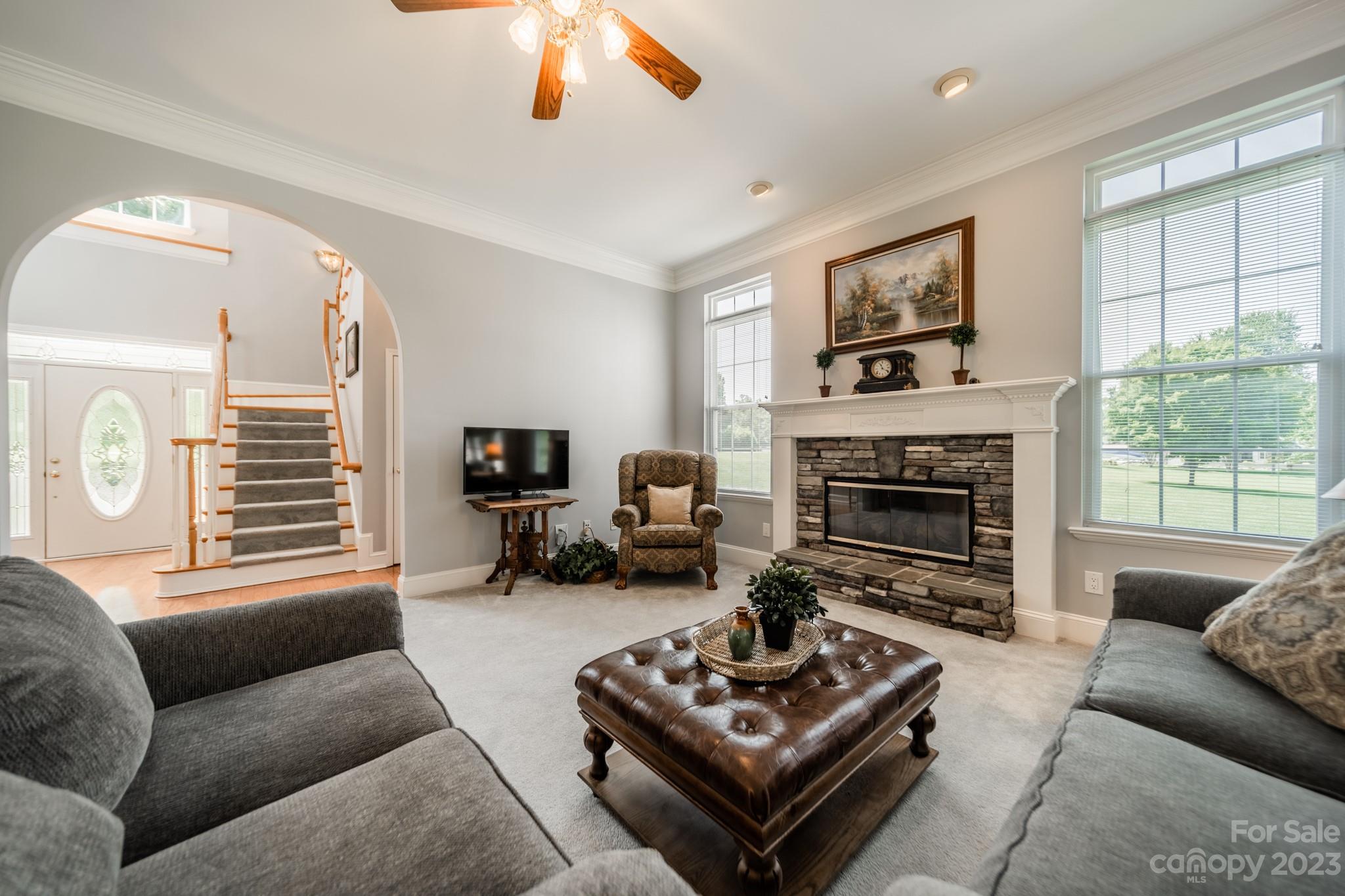 175 Perrin Road Mooresville, NC 28117 - Photo 13 of 45 a living room with furniture a fireplace a window and a flat screen tv