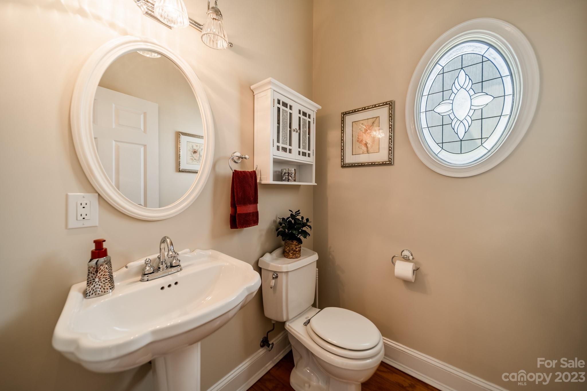 175 Perrin Road Mooresville, NC 28117 - Photo 14 of 45 a bathroom with a toilet a sink and a mirror