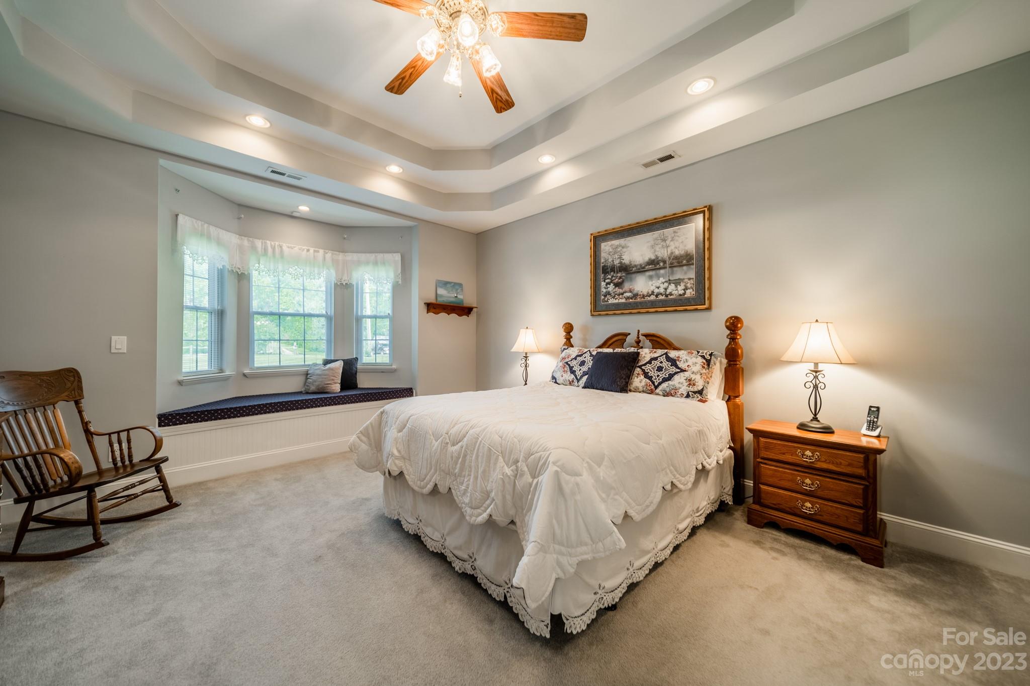 175 Perrin Road Mooresville, NC 28117 - Photo 16 of 45 a spacious bedroom with a bed and a chandelier