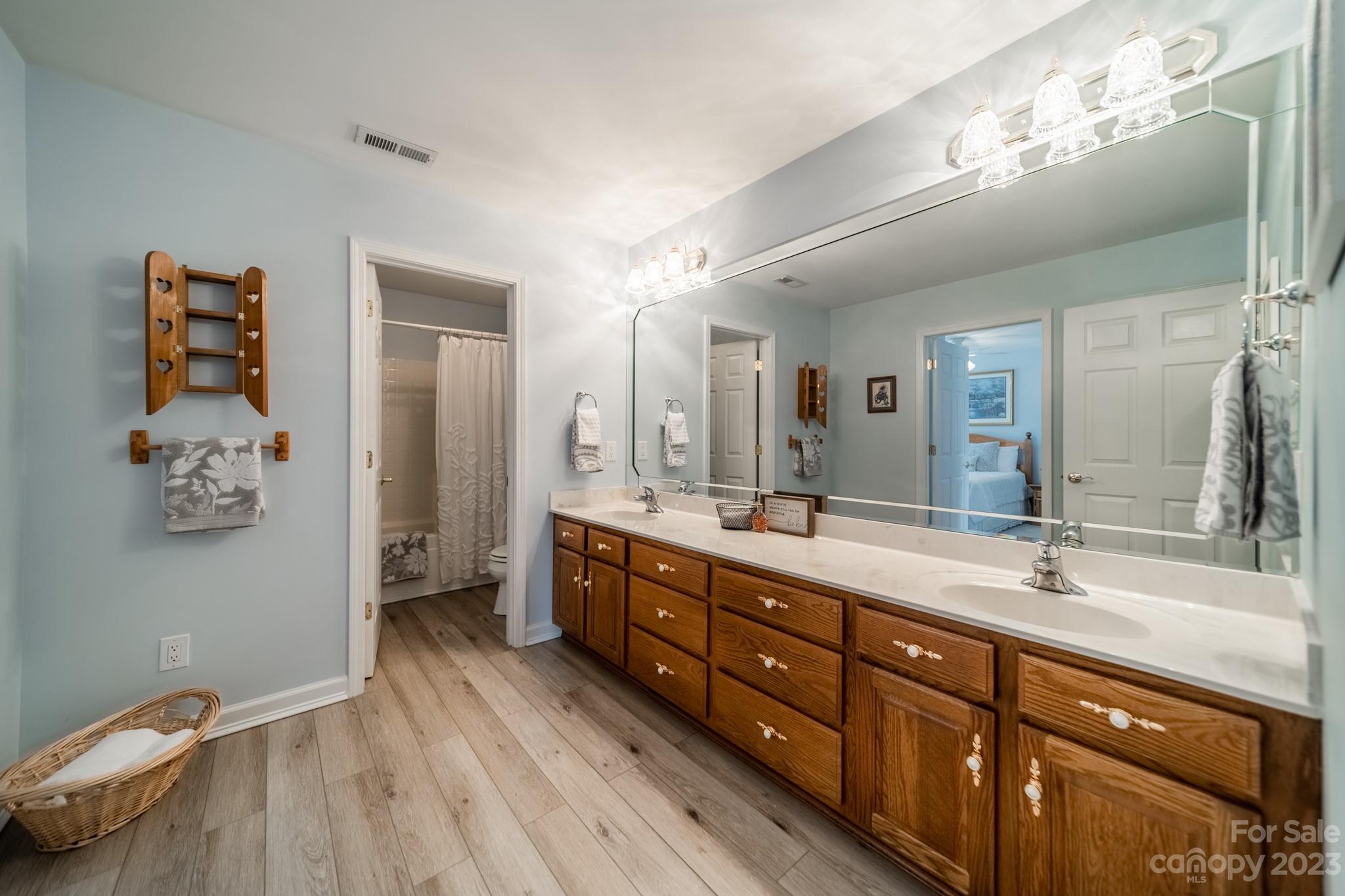 175 Perrin Road Mooresville, NC 28117 - Photo 25 of 45 a spacious bathroom with a double vanity sink and a mirror