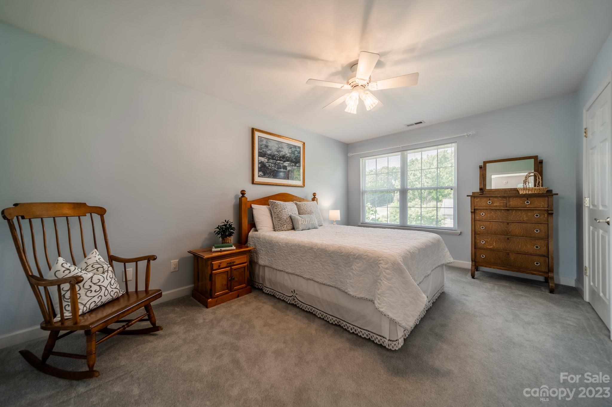 175 Perrin Road Mooresville, NC 28117 - Photo 26 of 45 a bedroom with a bed and a chandelier