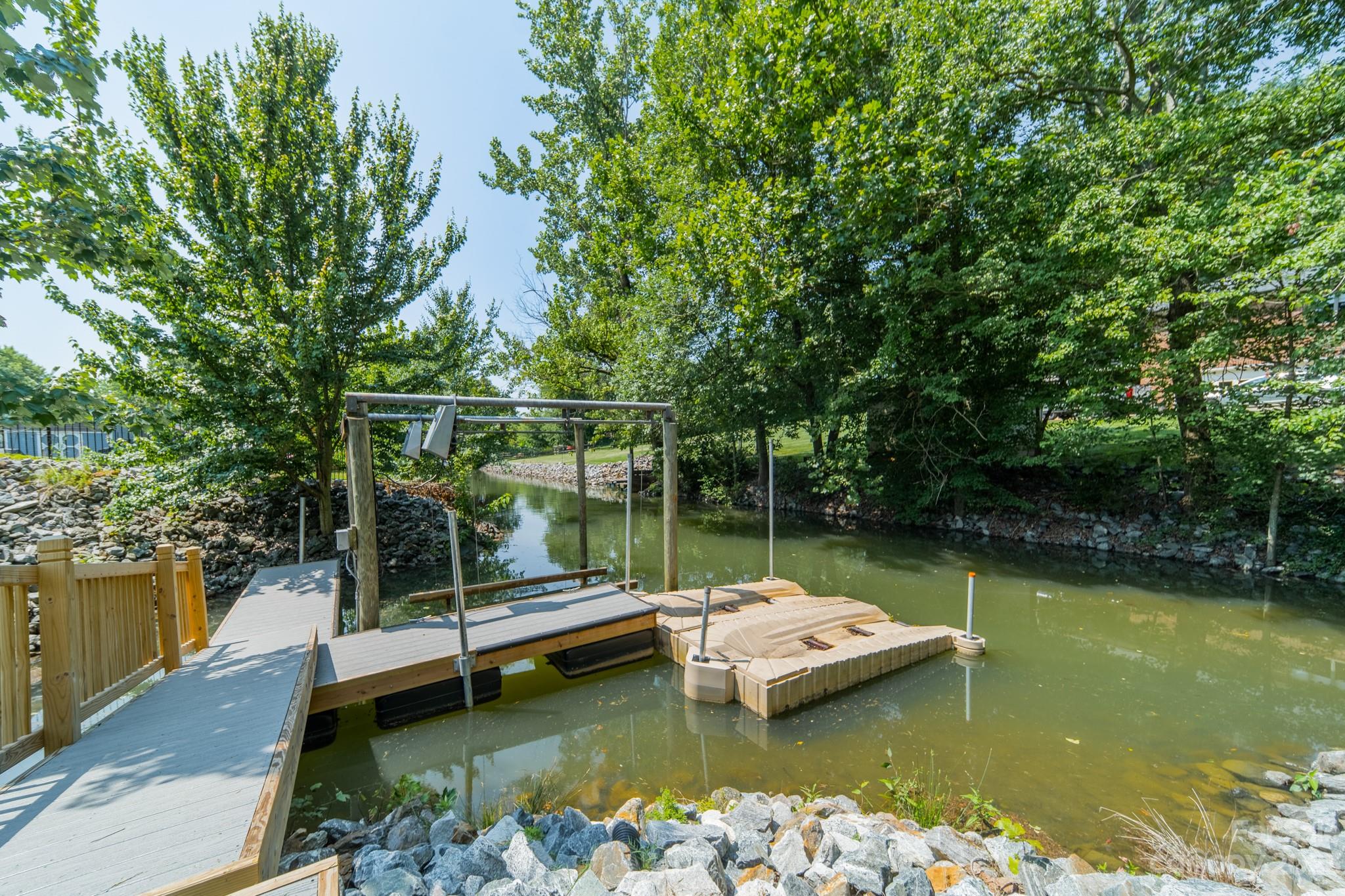 175 Perrin Road Mooresville, NC 28117 - Photo 42 of 45 a view of a lake with a deck