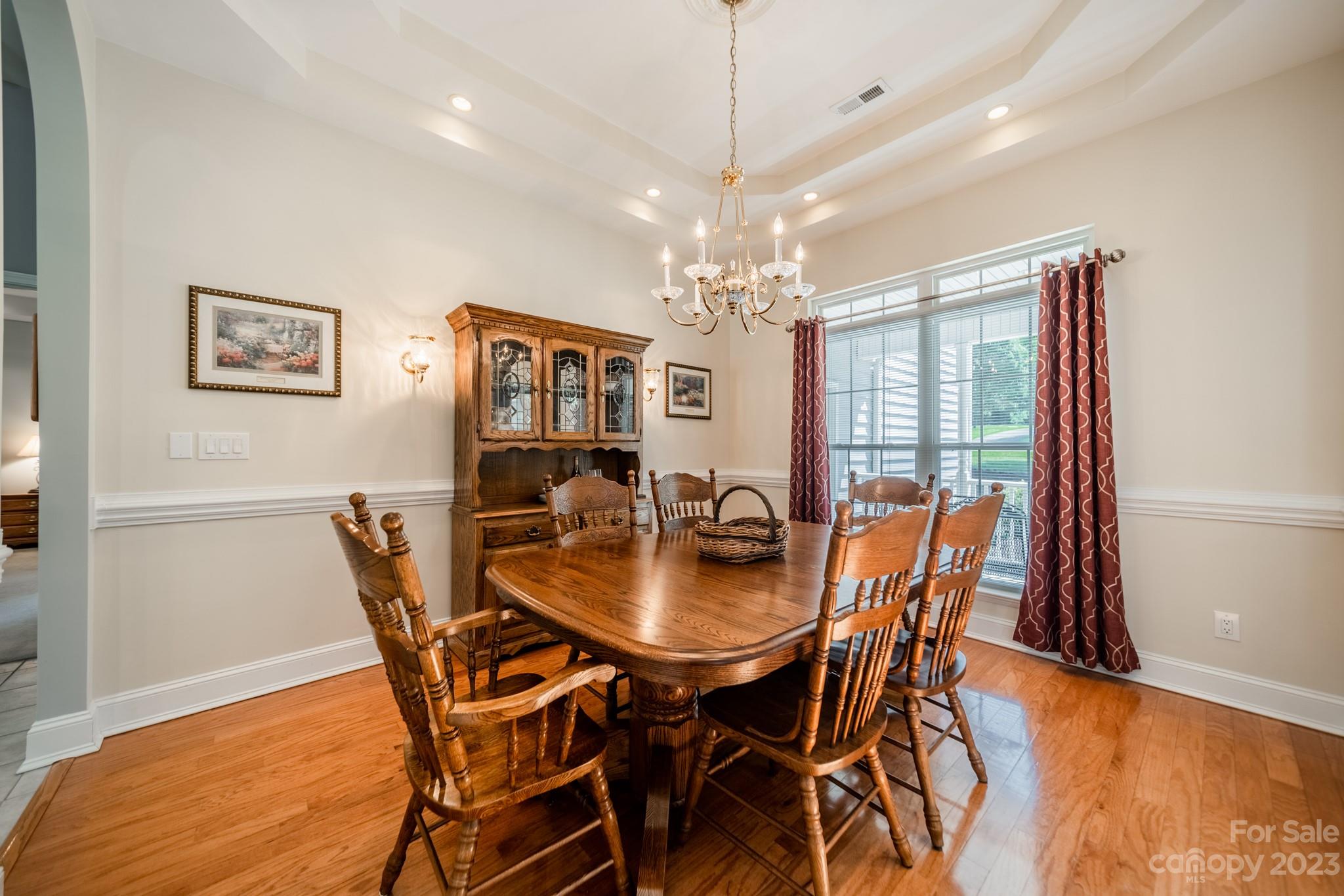 175 Perrin Road Mooresville, NC 28117 - Photo 6 of 45 a dining room with furniture a chandelier and wooden floor