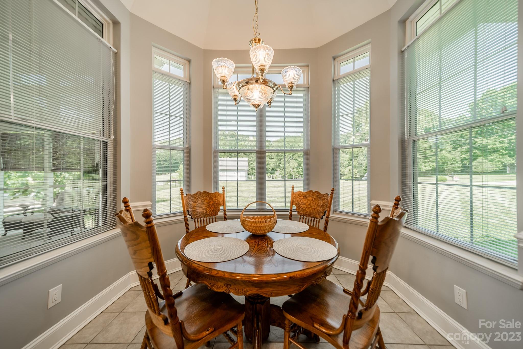 175 Perrin Road Mooresville, NC 28117 - Photo 10 of 45 a view of a dining room with furniture large windows and wooden floor