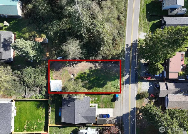 an aerial view of a houses with yard