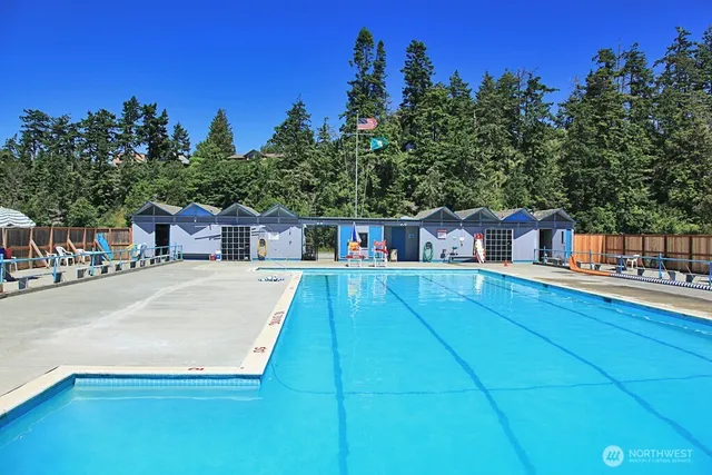 a view of a backyard with table and chairs and a fire pit