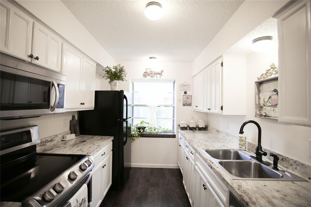 1720 Crystal Way Plano, TX 75074 - Photo 14 of 32 a kitchen with stainless steel appliances granite countertop a sink stove and refrigerator