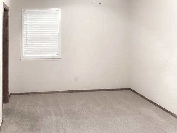 a view of an empty room with windows