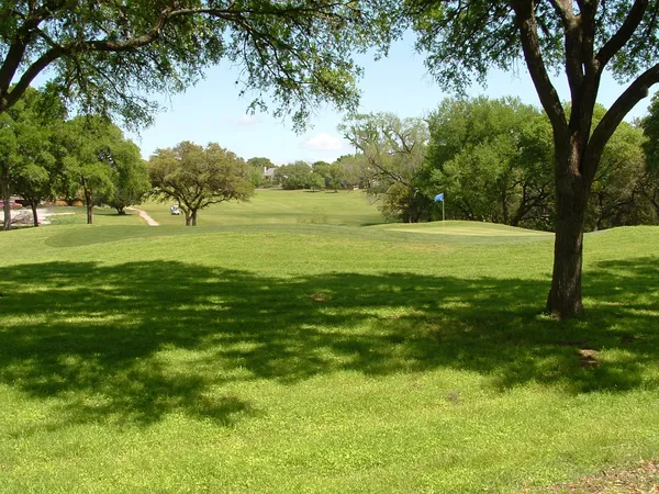 an aerial view of lake and residential houses with outdoor space