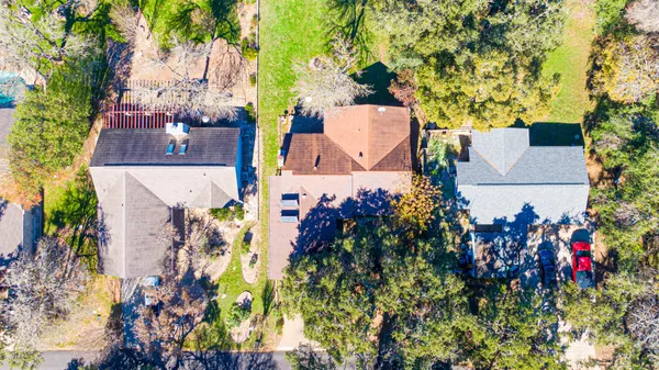 an aerial view of a houses with flower plants