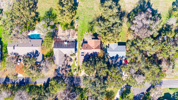 an aerial view of residential houses with outdoor space