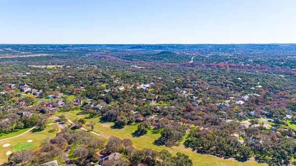a street sign on a sidewalk next to a road