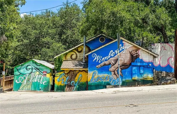 a view of a city with lush green forest