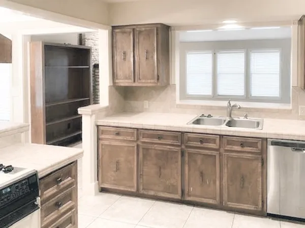 an empty room with fan and windows