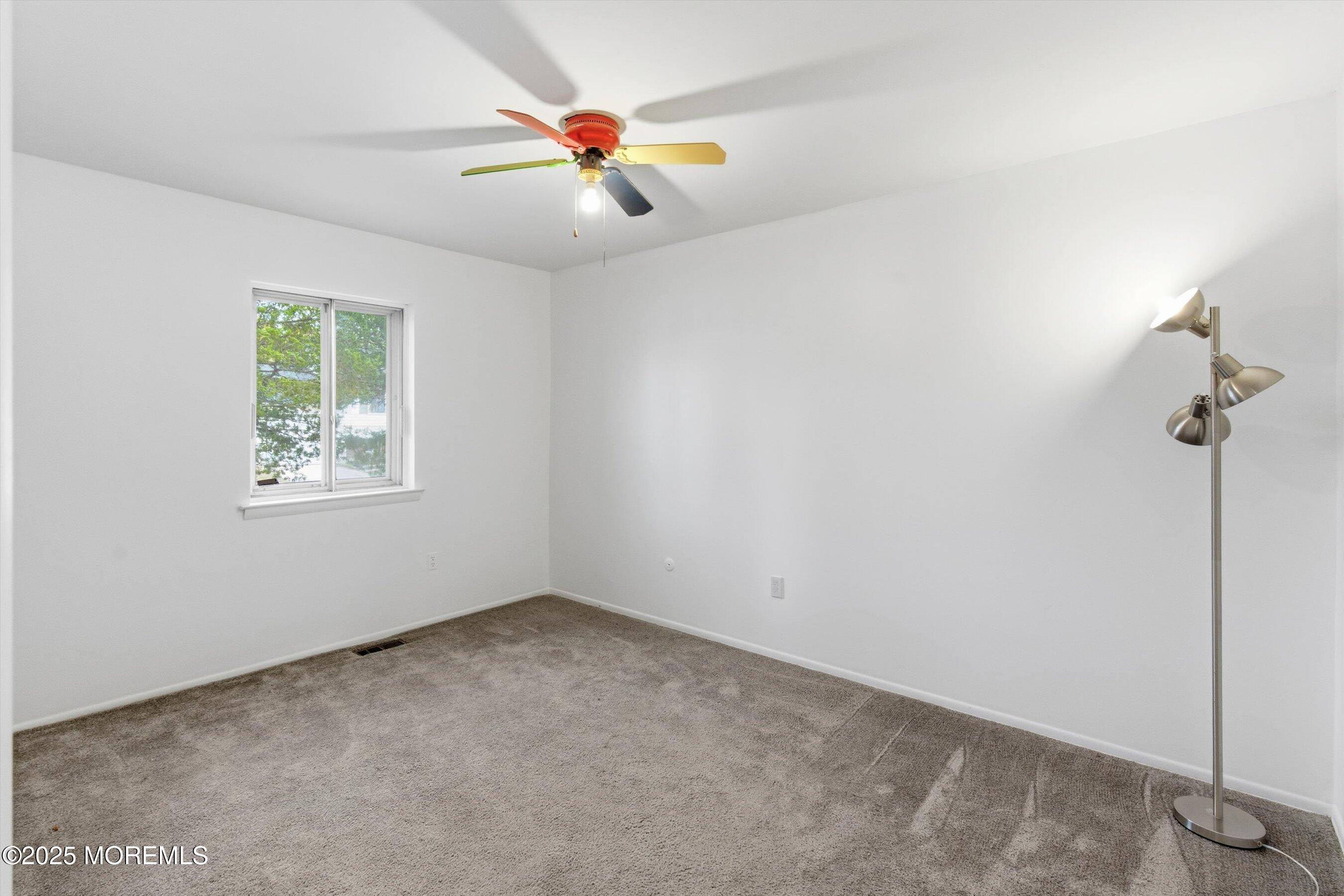 42 Monroe Avenue Browns Mills, NJ 08015 - Photo 12 of 29 an empty room with windows and fan