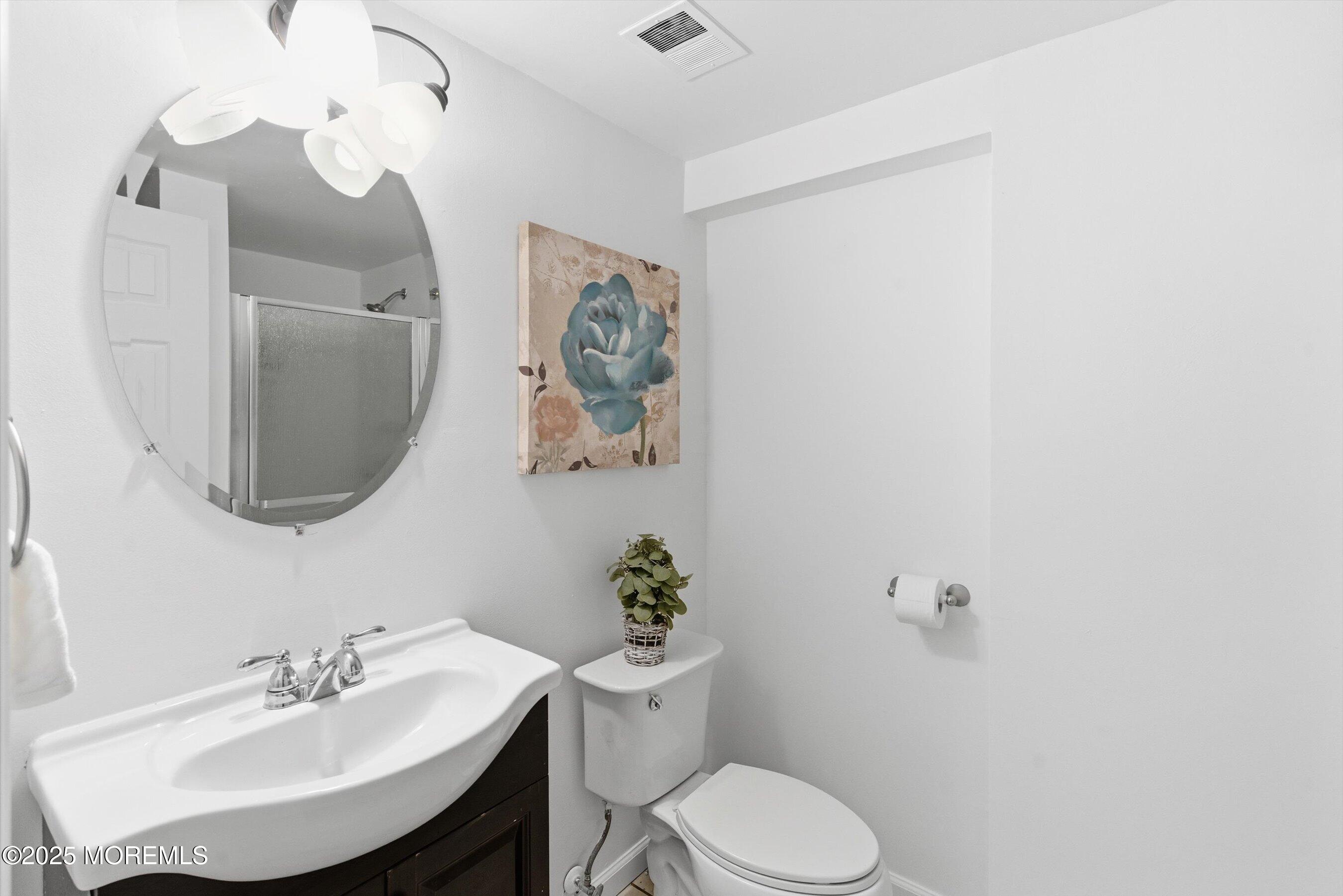 42 Monroe Avenue Browns Mills, NJ 08015 - Photo 18 of 29 a bathroom with a toilet a sink and mirror