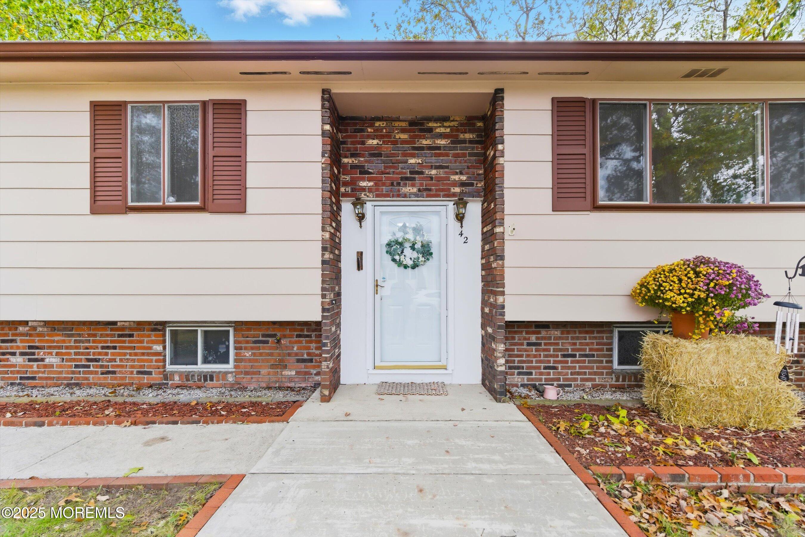 42 Monroe Avenue Browns Mills, NJ 08015 - Photo 2 of 29 a front view of a house with potted plants