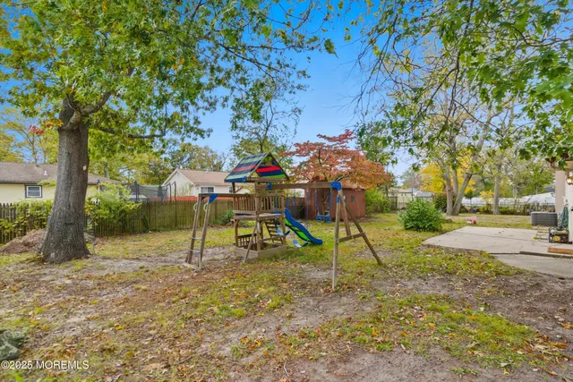 a view of outdoor space with playground and green space