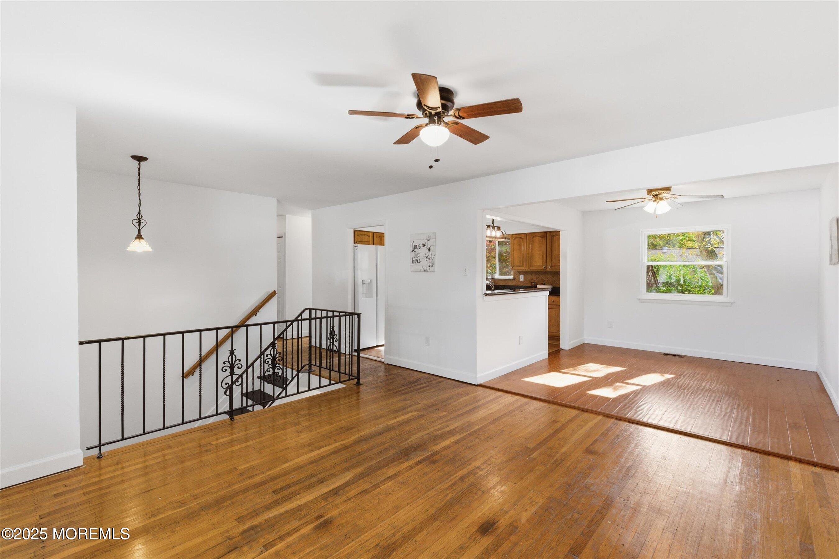 42 Monroe Avenue Browns Mills, NJ 08015 - Photo 5 of 29 a view of a livingroom with wooden floor and a ceiling fan