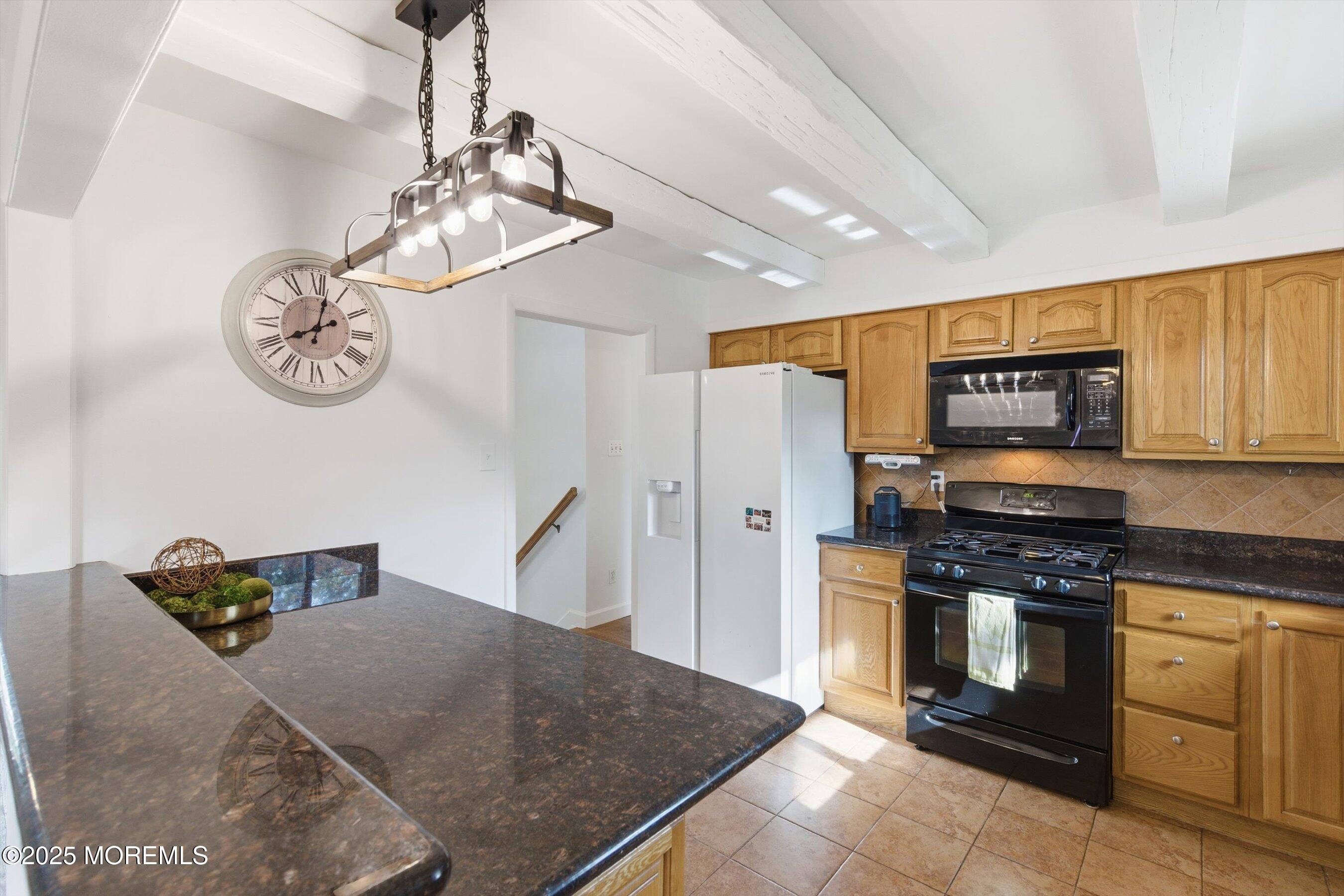 42 Monroe Avenue Browns Mills, NJ 08015 - Photo 7 of 29 a kitchen with stainless steel appliances granite countertop a stove and cabinets