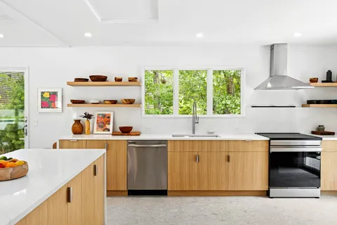 a kitchen with a sink a stove and a refrigerator