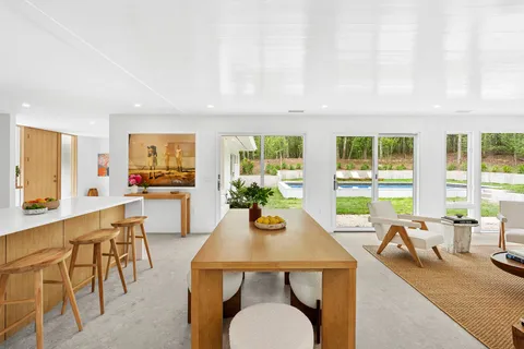 a view of a dining room with furniture a couch and wooden floor