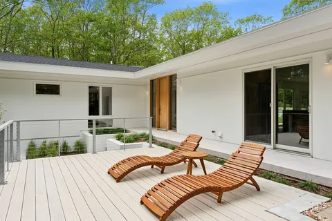 a bedroom with a bed and a chair next to a window