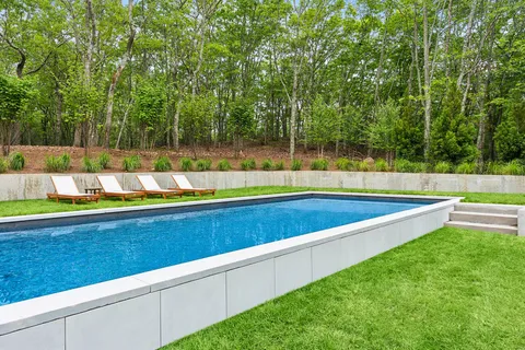a view of a backyard with a large pool and couches
